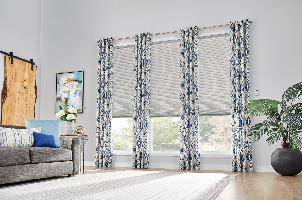 Windows: 3/4" Single Cell Cellular Shades with Motorized Lift: Couture, Noble Pewter 0133Drapery: Decorative Panels with Grommet Top: Kearney, Lakeshore 5760Hardware: 1" Finesse Pole in Brushed Nickel, 442